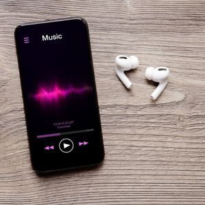 Earbuds and smartphone playing music